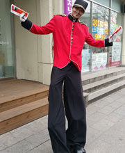 Man on stilts handing out pamphlets for LG electronics store in Seoul