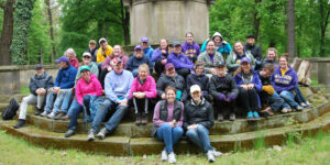 A group of students and professors at a Holocaust memorial.