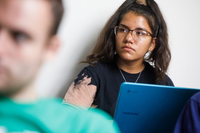 Student listening in a classroom setting.