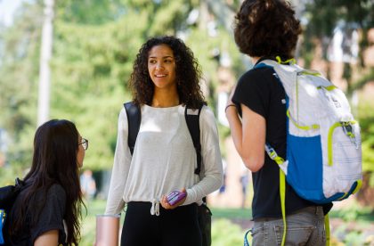 Students outside conversing on campus.