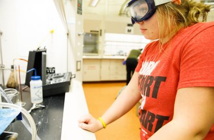 Student wearing goggles working in a lab