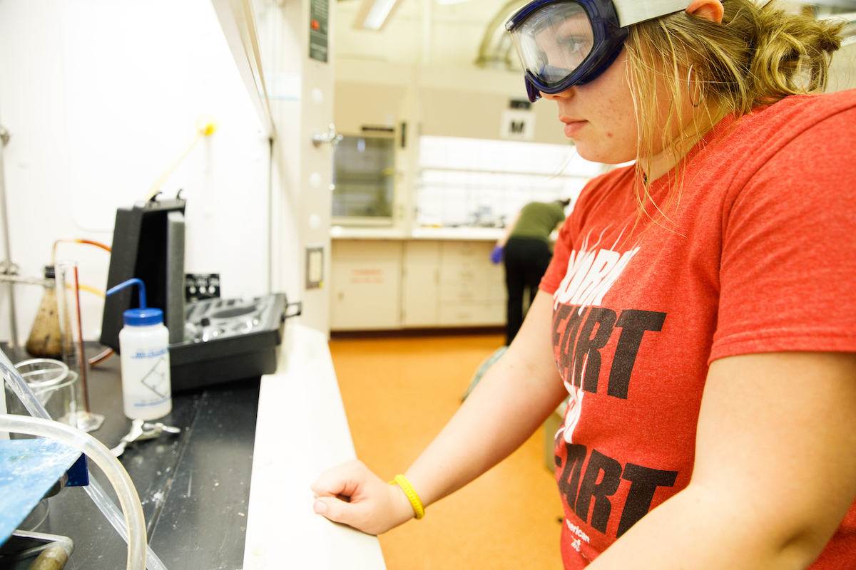 Student wearing goggles working in a lab