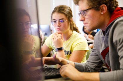 Two students working together on a computer