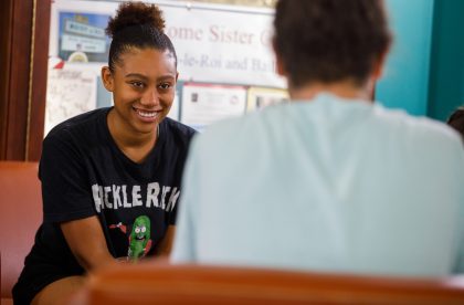 Two students having a conversation in a common area on campus