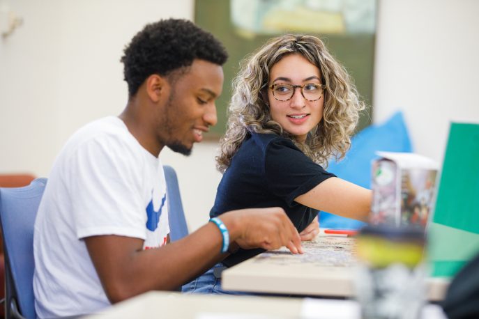 Two students working at a table