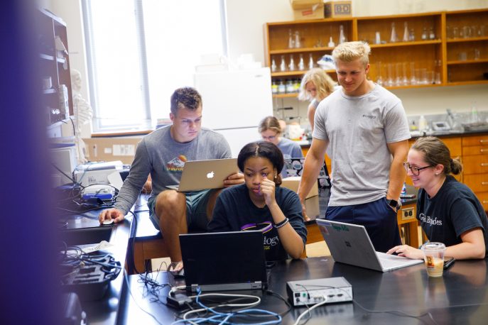 Group of Albion College students working together in a lab
