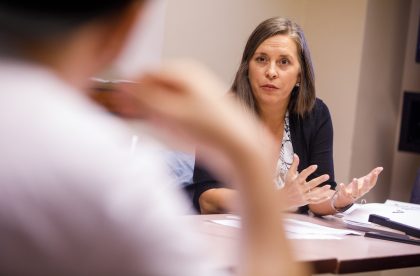 Faculty member speaking in a classroom setting.