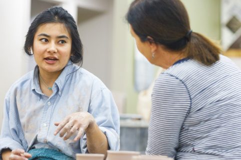 Two Albion College community members working in the pottery studio