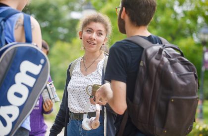 Students conversing outside on campus.