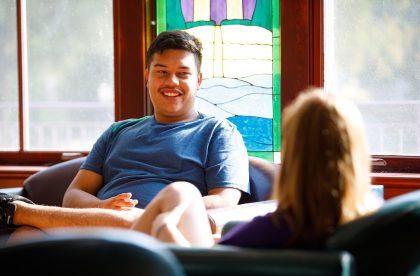 Two students talking in a common area on campus