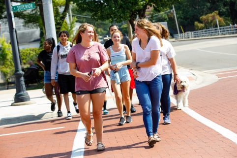 Group of Albion College students walking through downtown Albion.