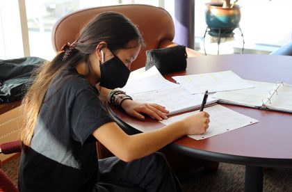 Albion College student working at a table