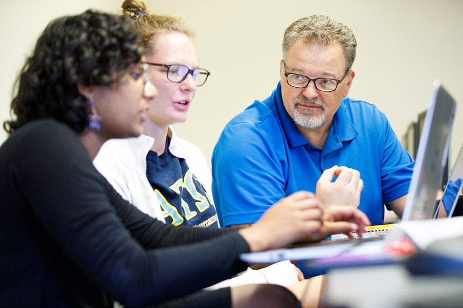 David Reimann (right), professor of mathematics and computer science, with two Albion College students.