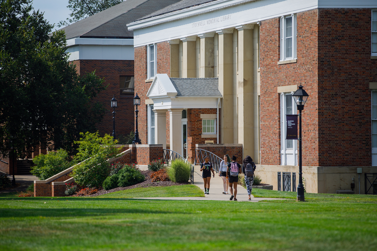 Students exit the Stockwell-Mudd Libraries on the Academic Quad. 
