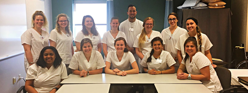 A group of Albion College students who completed the CNA program.