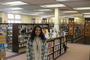 A student standing in the library.