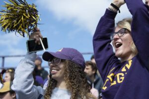 Students cheer on the football team at Homecoming 2019.