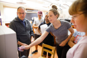 Christopher Rohlman, professor of biochemistry, leads a group of students in the lab.