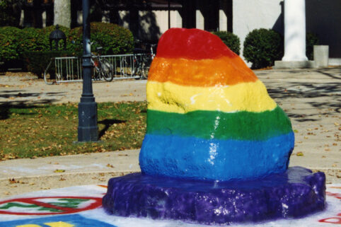 The Rock painted with the pride flag colors.