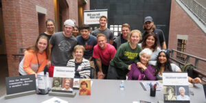 A group of people posed behind a table.