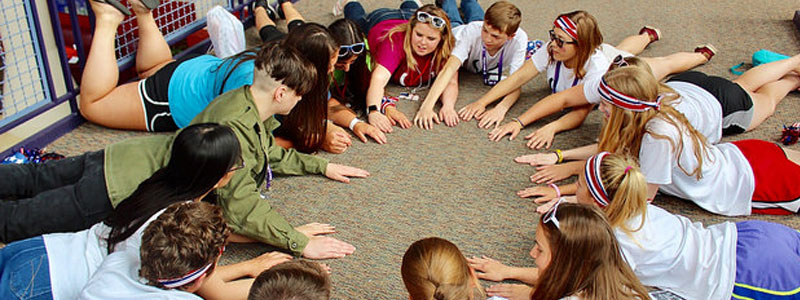 Students sitting in a circle on the floor