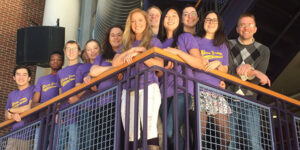 Professor Craig Streu and his group of students standing on a balcony.