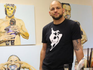 Michael Dixon standing in front of his paintings.