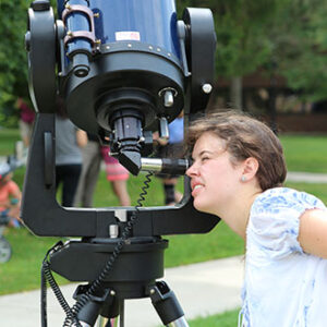Someone looking into a telescope.
