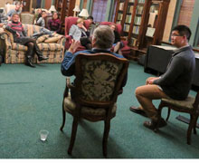 Two men sitting in chairs from behind.