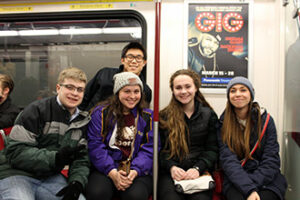 A group of students posing on the subway.