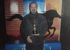 Jason Moritz holding an Oscar.