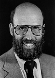 A headshot of a man in a suit.