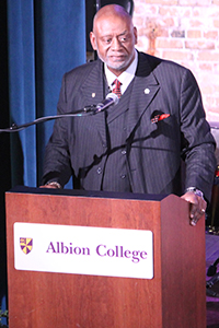 A speaker  behind a podium.