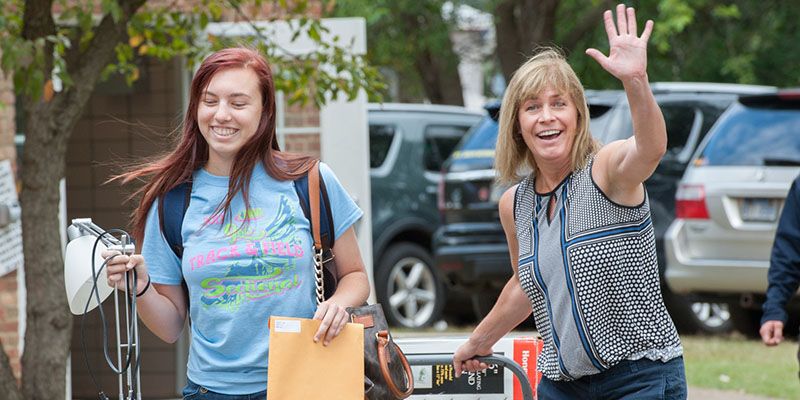 A student and a guardian moving into Wesley Hall.