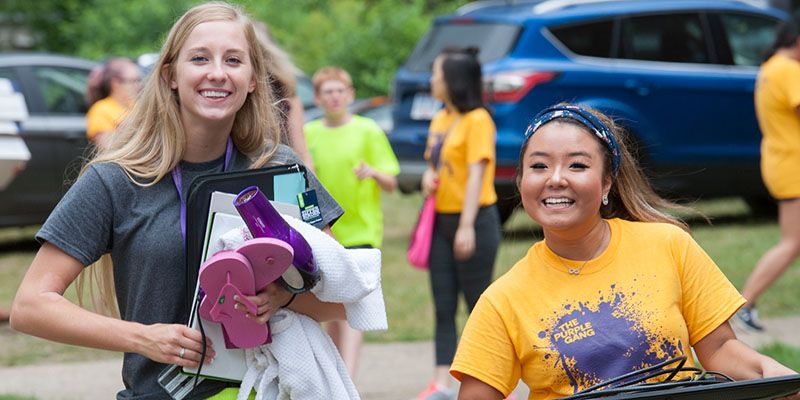 Two students moving in their things.