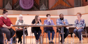 A panel of people sitting at a table.