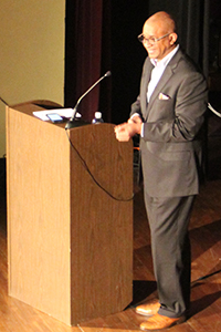 A speaker standing behind a podium.