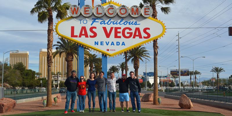 A group of students standing in front of a "Las Vegas" sign.