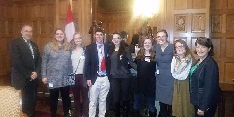 A group of students standing inside.