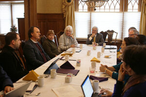 A group of people sitting around a table.