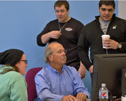 A professor surrounded by students.