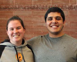 Two students smiling at the camera.