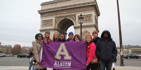 Group of students holding an Albin flag in France.