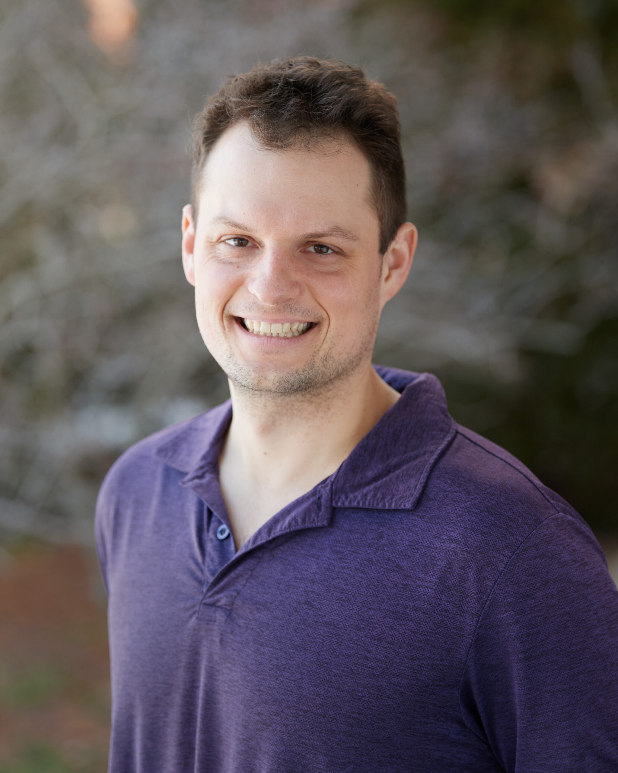 A professional headshot of Drew Ash.