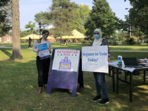 A staff member and student at a voter registration drive.