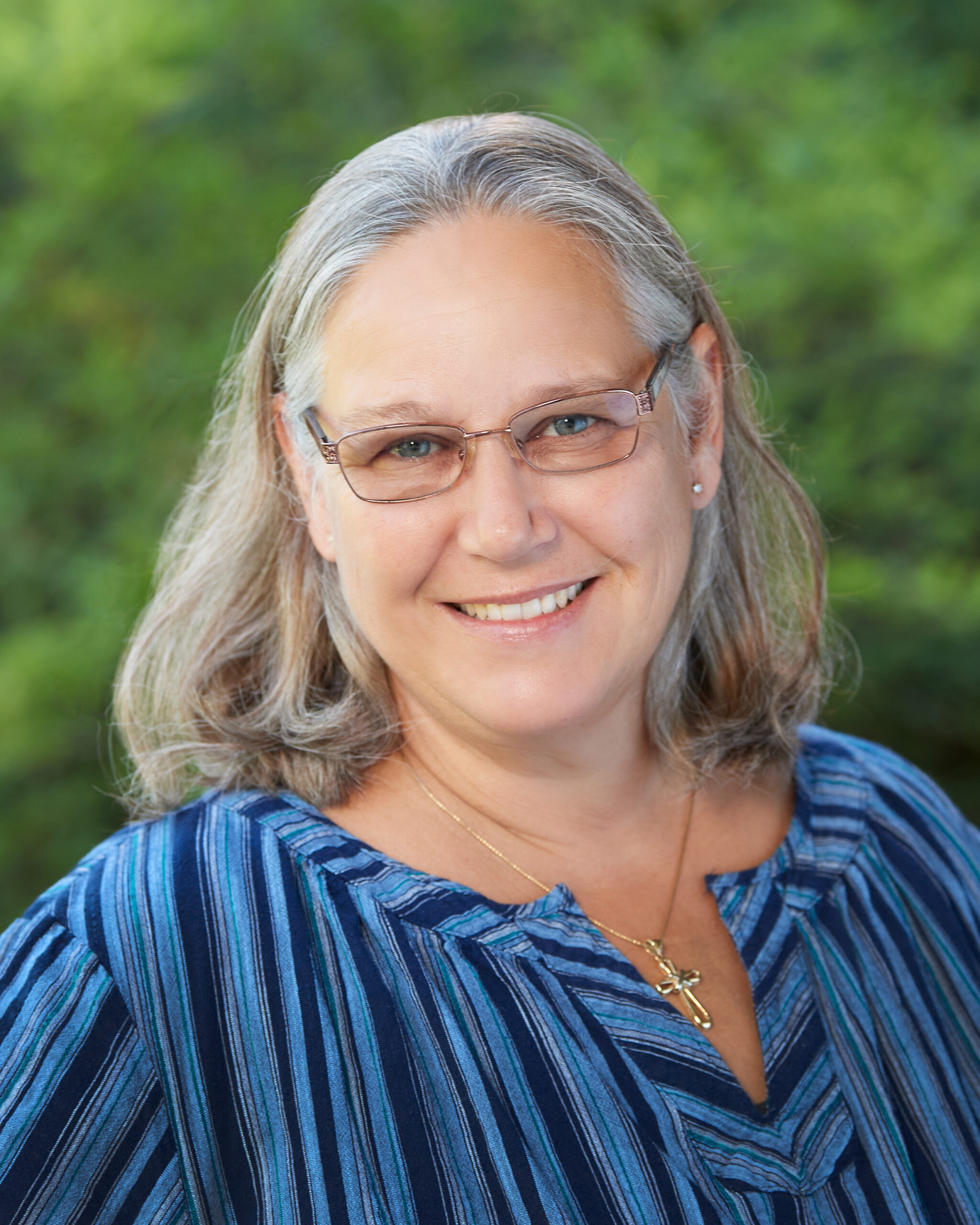 A professional headshot of Schara Swan.