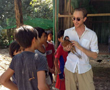 Cucinella with children building the home's new chicken coop.