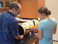 Physics professor Aaron Miller and Holly Farris drill a portion of the telescope.