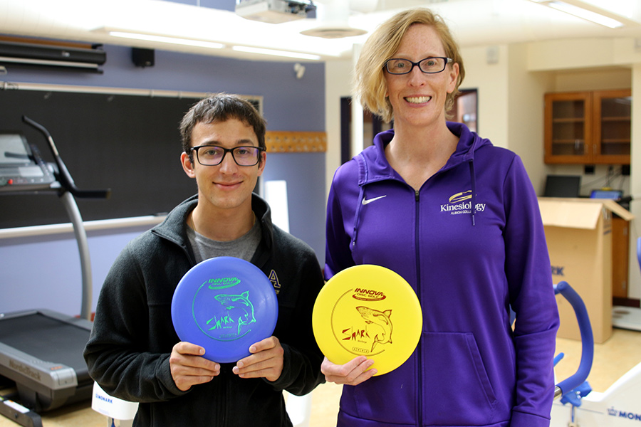 Tyler Hood and Julie Cousins holding frisbees.