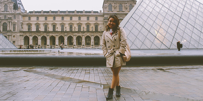 Sunny Kim standing in front of a building in Paris.